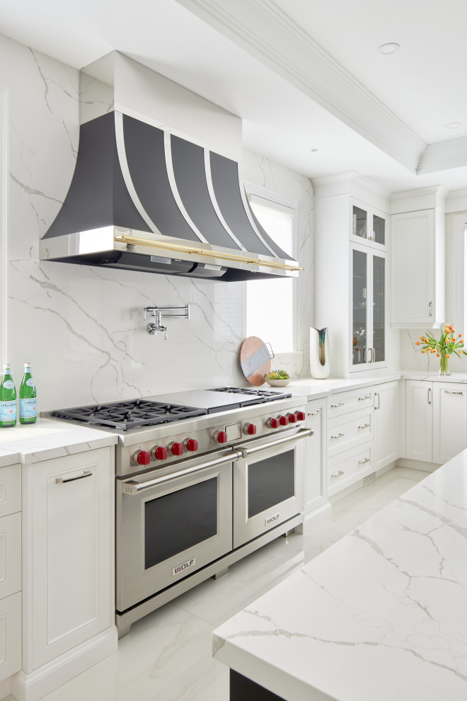 Inspiration for a transitional galley separate kitchen in Toronto with shaker cabinets, white cabinets, quartz benchtops, white splashback, granite splashback, stainless steel appliances, marble floors, with island, white floor, white benchtop and recessed.