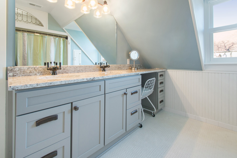 This is an example of a mid-sized transitional bathroom in Milwaukee with flat-panel cabinets, beige cabinets, an alcove tub, grey walls, concrete floors, an undermount sink, granite benchtops and beige floor.