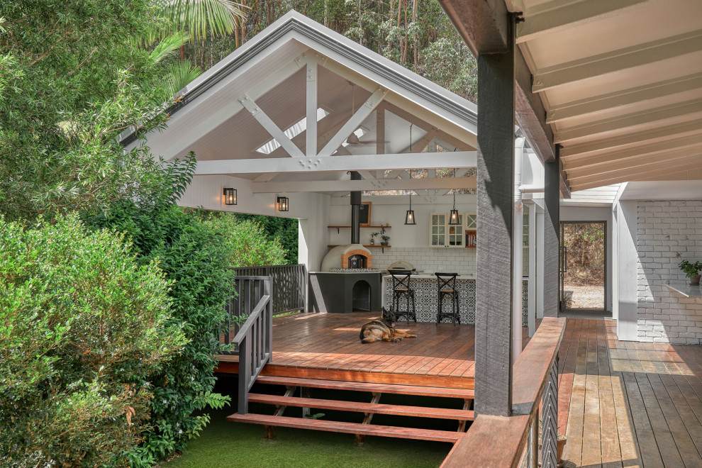 Photo of a mid-sized traditional backyard deck in Gold Coast - Tweed with an outdoor kitchen and a roof extension.