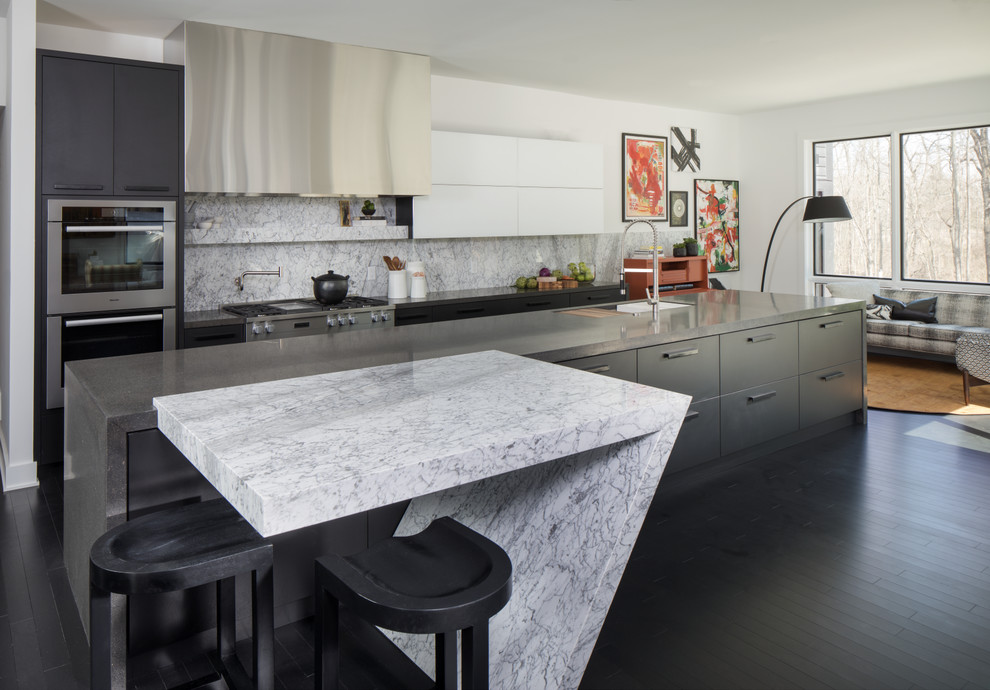 Inspiration for an expansive transitional single-wall eat-in kitchen in Indianapolis with an undermount sink, flat-panel cabinets, black cabinets, quartz benchtops, white splashback, marble splashback, stainless steel appliances, dark hardwood floors, with island and black floor.