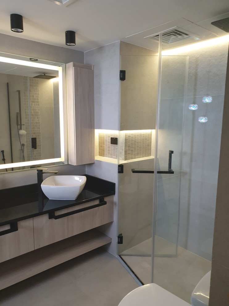Mid-sized modern master bathroom in Other with flat-panel cabinets, beige cabinets, a freestanding tub, a curbless shower, a one-piece toilet, gray tile, ceramic tile, grey walls, ceramic floors, a console sink, granite benchtops, grey floor, a hinged shower door and black benchtops.