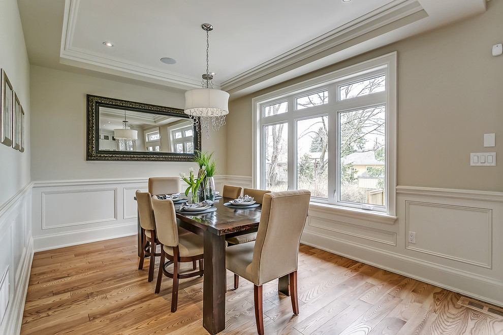 Inspiration for a mid-sized traditional separate dining room in Toronto with grey walls, light hardwood floors and no fireplace.