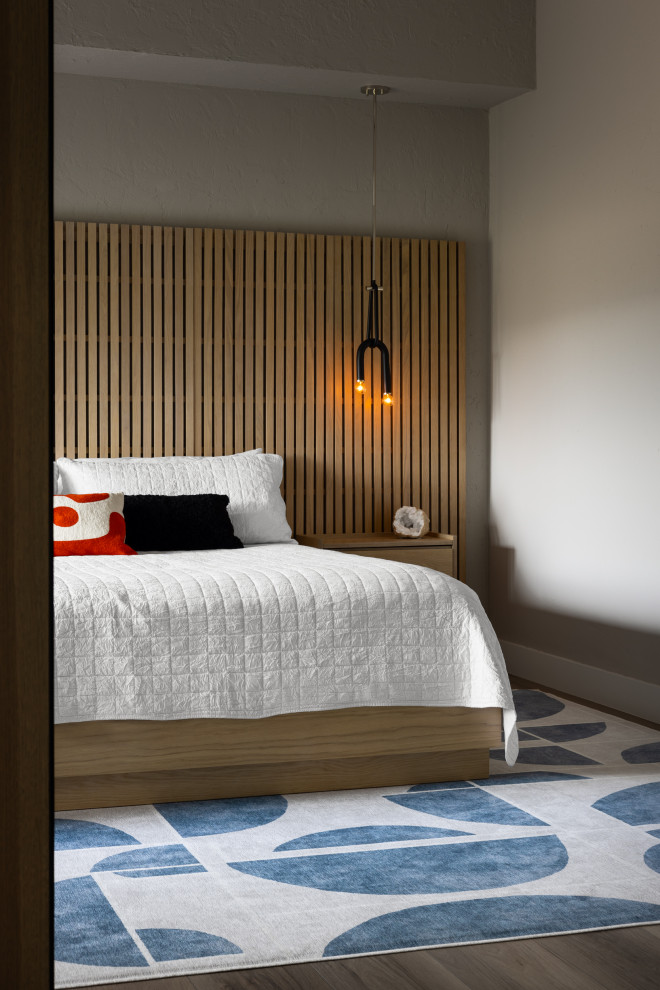 Inspiration for a contemporary dark wood floor, brown floor and wood wall bedroom remodel in Denver with gray walls