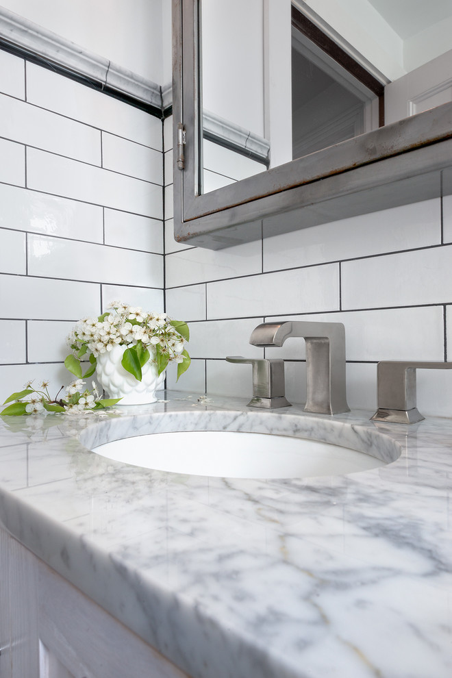 Inspiration for a small eclectic master bathroom in Philadelphia with an undermount sink, shaker cabinets, white cabinets, marble benchtops, an alcove tub, a shower/bathtub combo, a one-piece toilet, white tile, ceramic tile, white walls and marble floors.