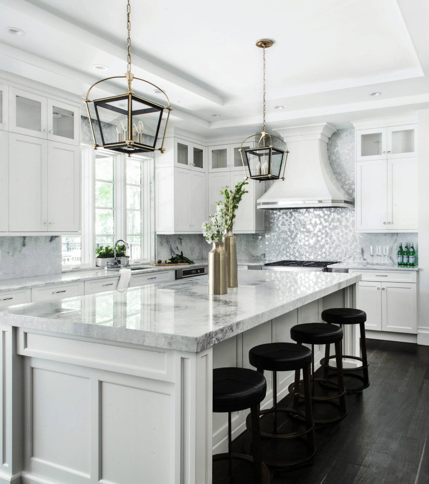 Photo of a transitional l-shaped kitchen in Toronto with an undermount sink, shaker cabinets, white cabinets, grey splashback, stainless steel appliances, dark hardwood floors, with island, black floor, grey benchtop and recessed.