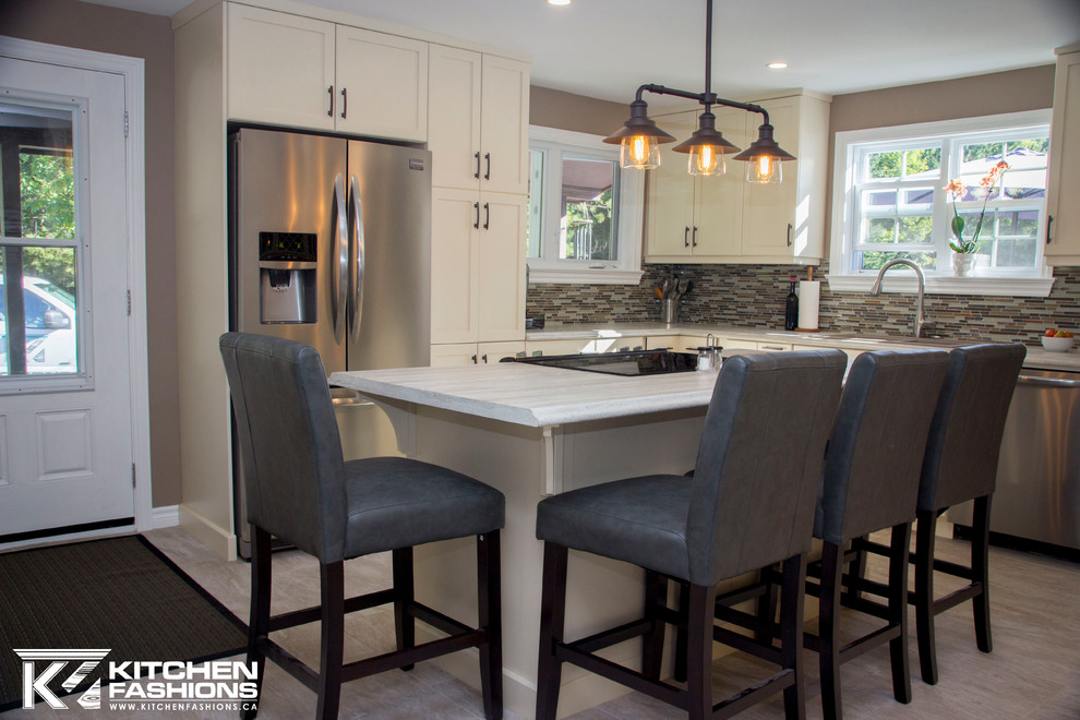 Inspiration for a large contemporary u-shaped vinyl floor open concept kitchen remodel with a drop-in sink, shaker cabinets, beige cabinets, laminate countertops, multicolored backsplash, glass tile backsplash, stainless steel appliances and an island