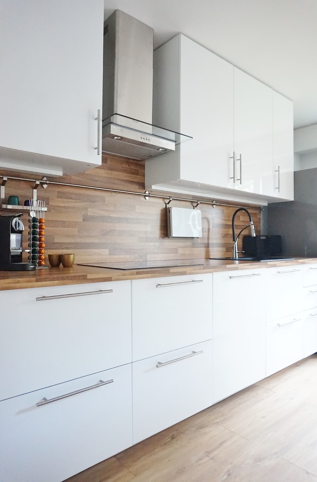 Design ideas for a large contemporary open plan kitchen in Paris with white cabinets, laminate benchtops, brown splashback, stainless steel appliances, vinyl floors and with island.