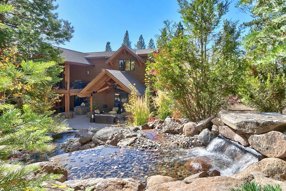 This is an example of a large transitional drought-tolerant and partial sun backyard concrete paver water fountain landscape for summer.