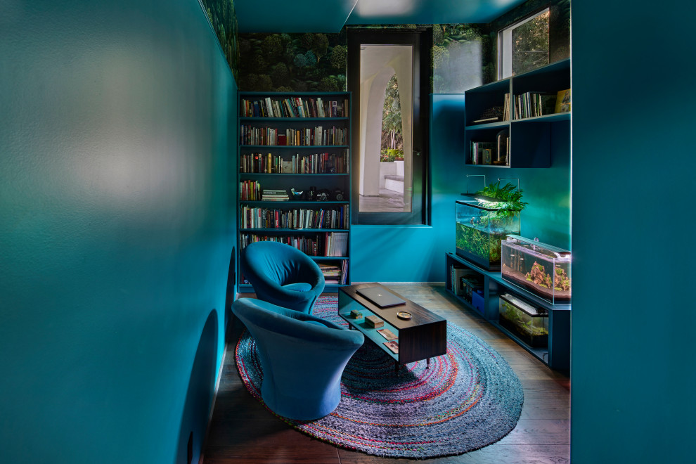 Large mediterranean enclosed living room in Los Angeles with blue walls, dark hardwood floors, no fireplace, no tv, brown floor, recessed and wallpaper.
