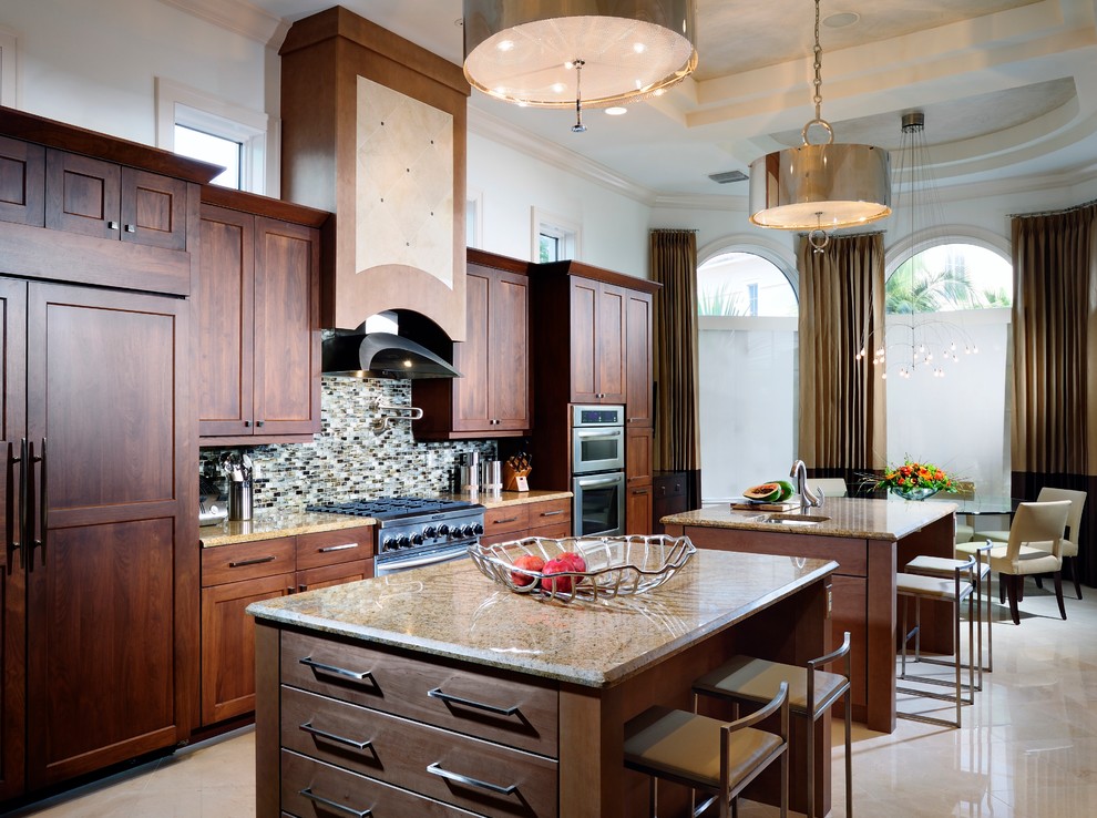This is an example of a contemporary eat-in kitchen in Miami with mosaic tile splashback.