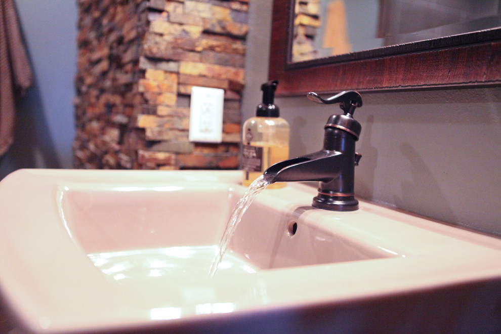 Example of a mid-sized mountain style 3/4 multicolored tile and pebble tile porcelain tile corner shower design with open cabinets, dark wood cabinets, a two-piece toilet, blue walls and a pedestal sink