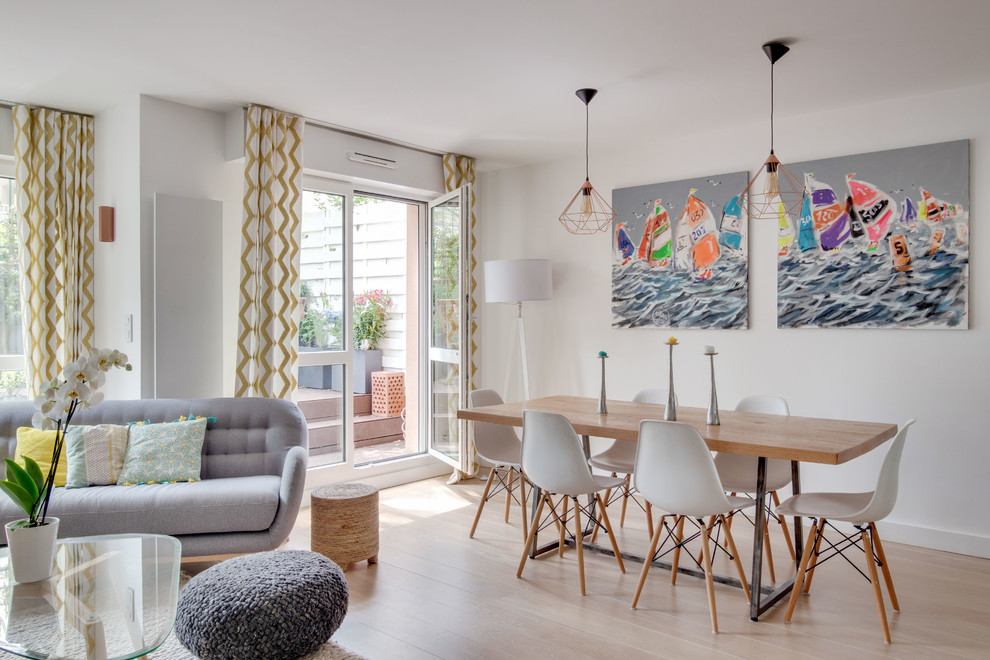 Photo of a contemporary open plan dining in Paris with white walls and beige floor.