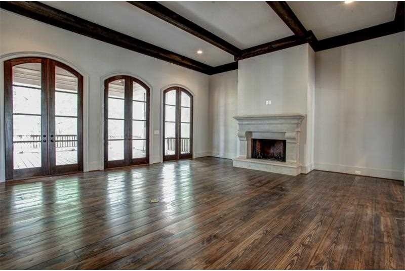 Expansive arts and crafts formal enclosed living room in Atlanta with grey walls, dark hardwood floors, a standard fireplace and a stone fireplace surround.