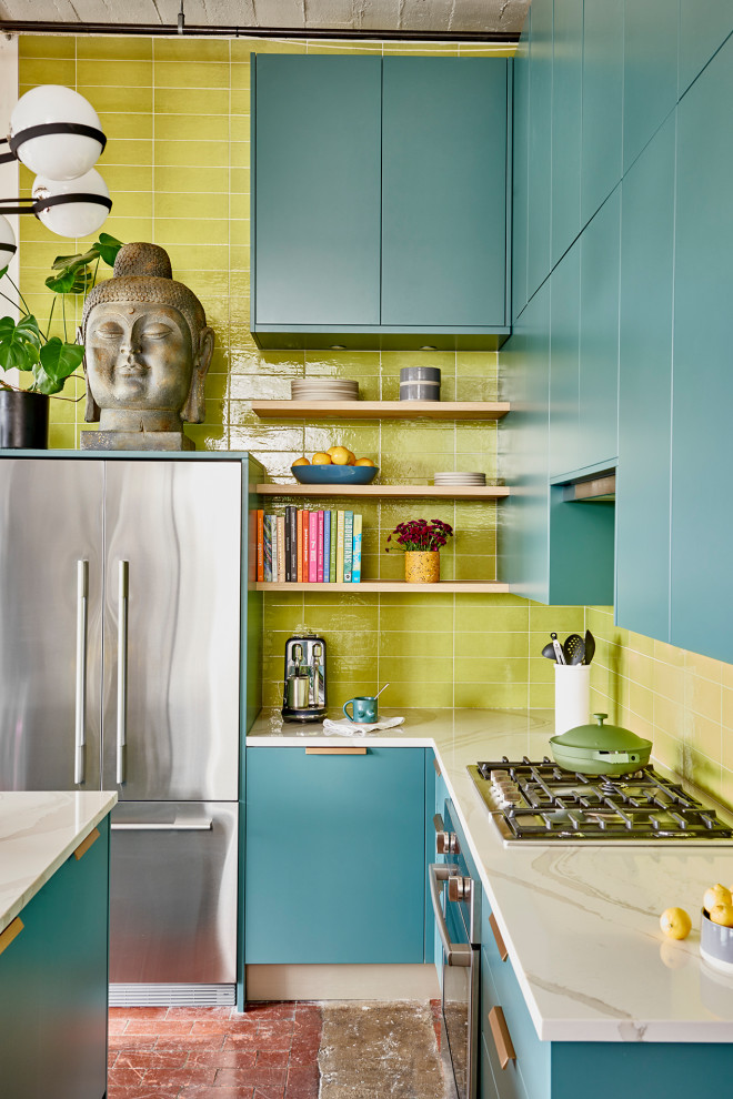 Inspiration for a mid-sized modern l-shaped eat-in kitchen in Atlanta with an undermount sink, flat-panel cabinets, green cabinets, quartz benchtops, yellow splashback, ceramic splashback, stainless steel appliances, concrete floors, with island, grey floor and white benchtop.