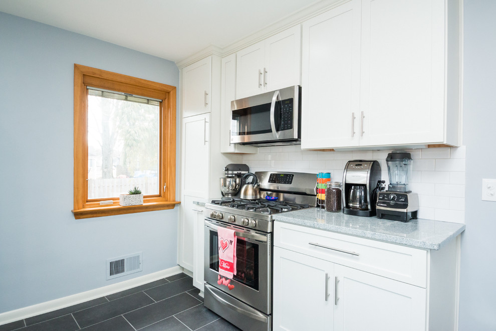 Mid-sized transitional l-shaped eat-in kitchen photo in Columbus with an undermount sink, shaker cabinets, white cabinets, granite countertops, white backsplash, subway tile backsplash and stainless steel appliances