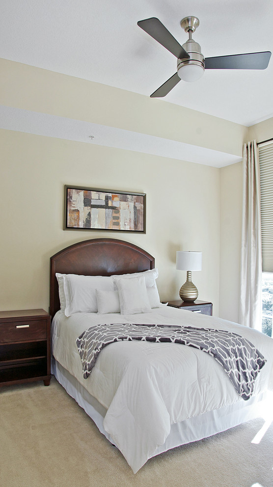 Design ideas for a mid-sized transitional guest bedroom in Jacksonville with beige walls and carpet.