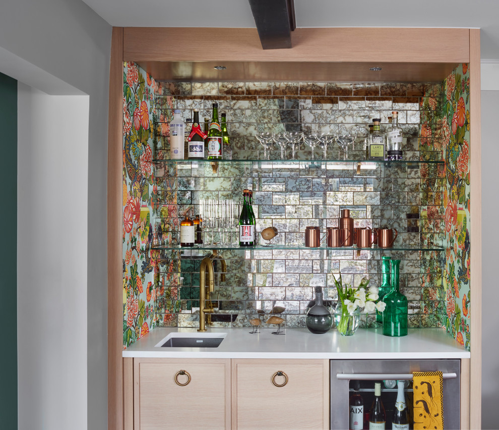 This is an example of a small modern single-wall wet bar in Denver with an undermount sink, shaker cabinets, light wood cabinets, quartz benchtops, multi-coloured splashback, mirror splashback, medium hardwood floors, brown floor and yellow benchtop.