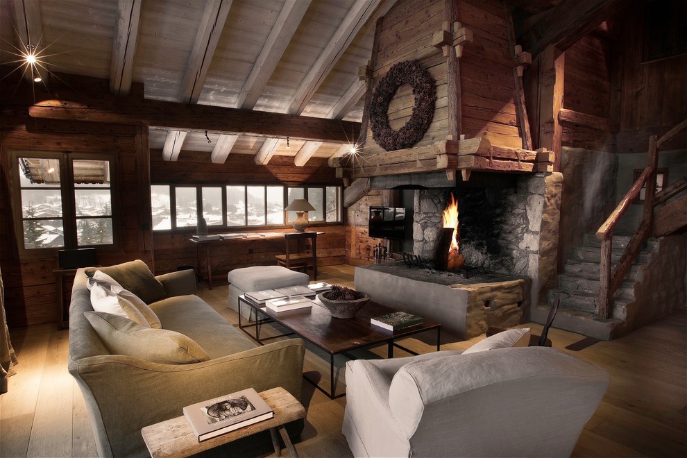 Design ideas for a large country open concept family room in Lyon with light hardwood floors, a standard fireplace and a wall-mounted tv.