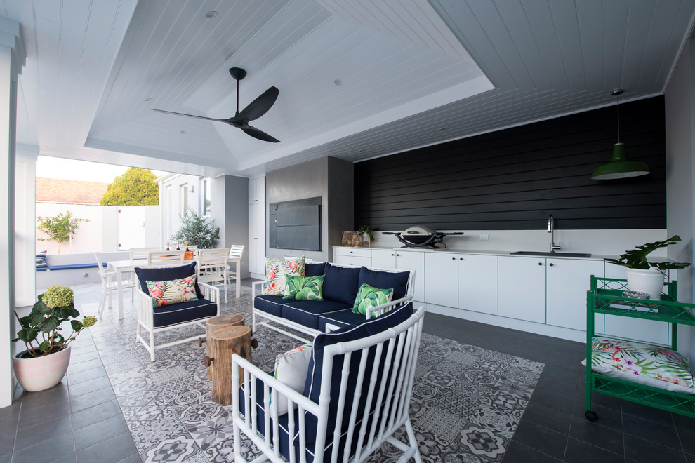 Inspiration for a large transitional backyard patio in Perth with an outdoor kitchen, tile and a roof extension.