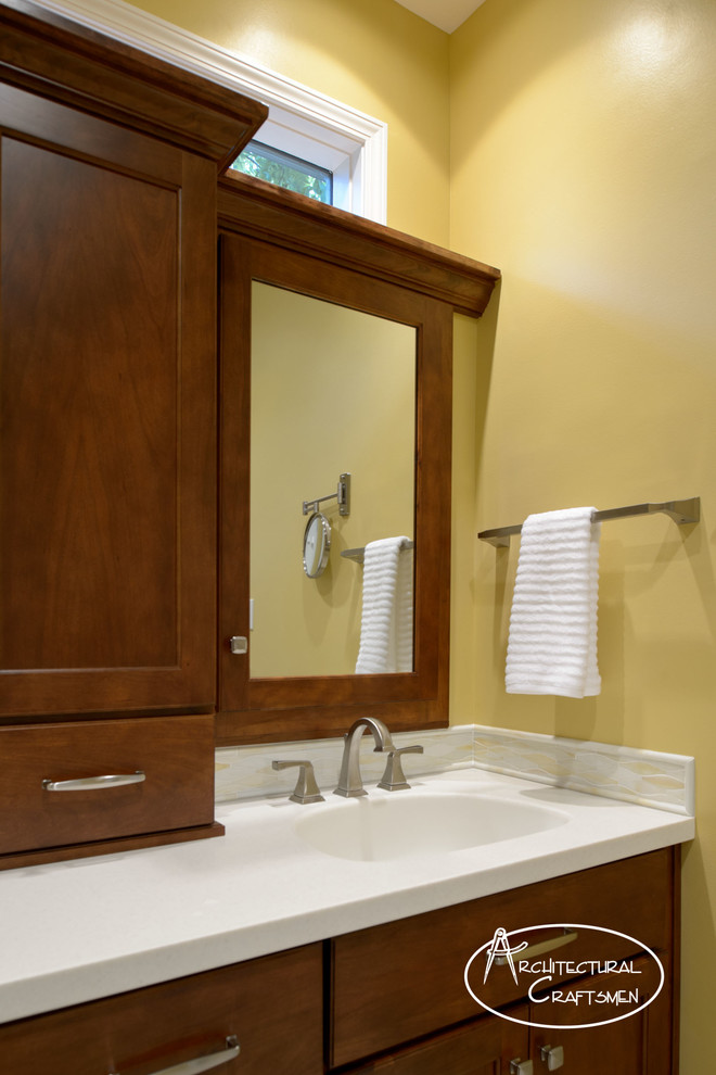 Inspiration for a large traditional master bathroom in Kansas City with an undermount sink, shaker cabinets, dark wood cabinets, glass benchtops, an undermount tub, a curbless shower, white tile, glass tile, yellow walls and porcelain floors.
