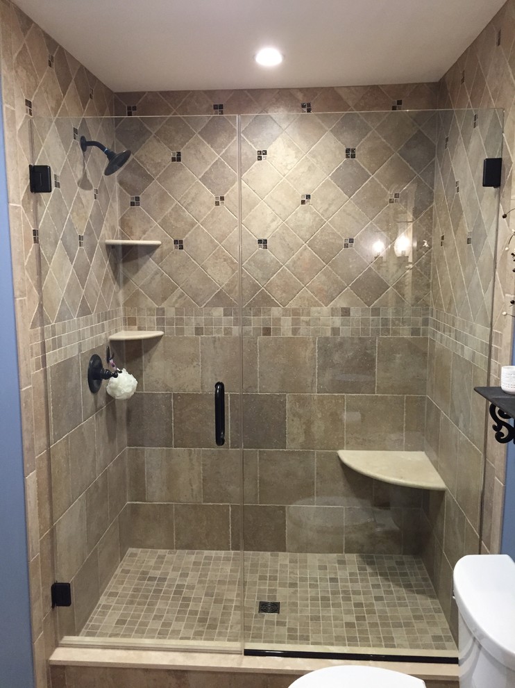 Inspiration for a small contemporary master bathroom in Philadelphia with recessed-panel cabinets, light wood cabinets, an alcove shower, a two-piece toilet, beige tile, porcelain tile, blue walls, porcelain floors, an undermount sink and granite benchtops.