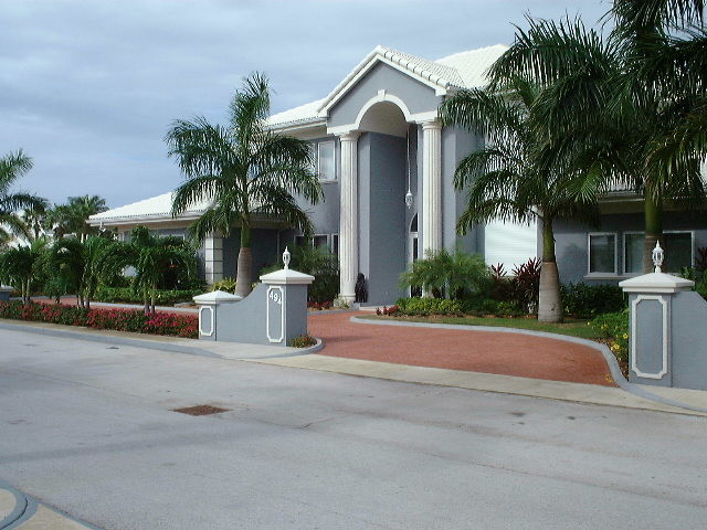 Huge front door photo in Phoenix with beige walls and a medium wood front door