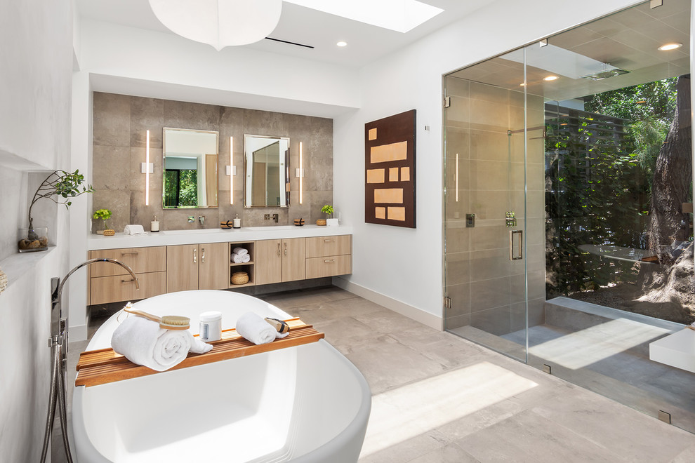 Design ideas for a contemporary master bathroom in Los Angeles with flat-panel cabinets, light wood cabinets, an alcove shower, beige tile, white walls, grey floor, a hinged shower door and white benchtops.