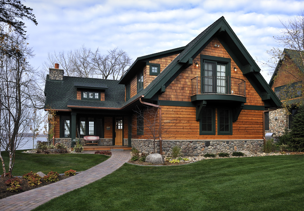 This is an example of a traditional exterior in Minneapolis with wood siding.