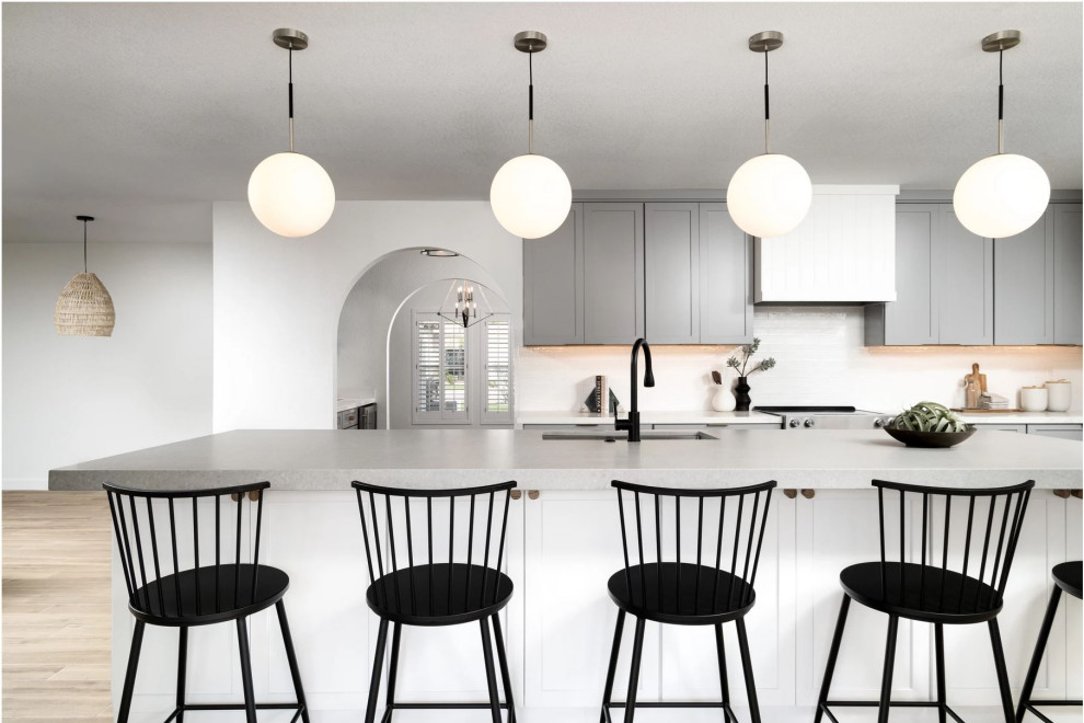 Kitchen - large transitional galley beige floor kitchen idea in Phoenix with a farmhouse sink, shaker cabinets, gray cabinets, white backsplash, paneled appliances, two islands and white countertops