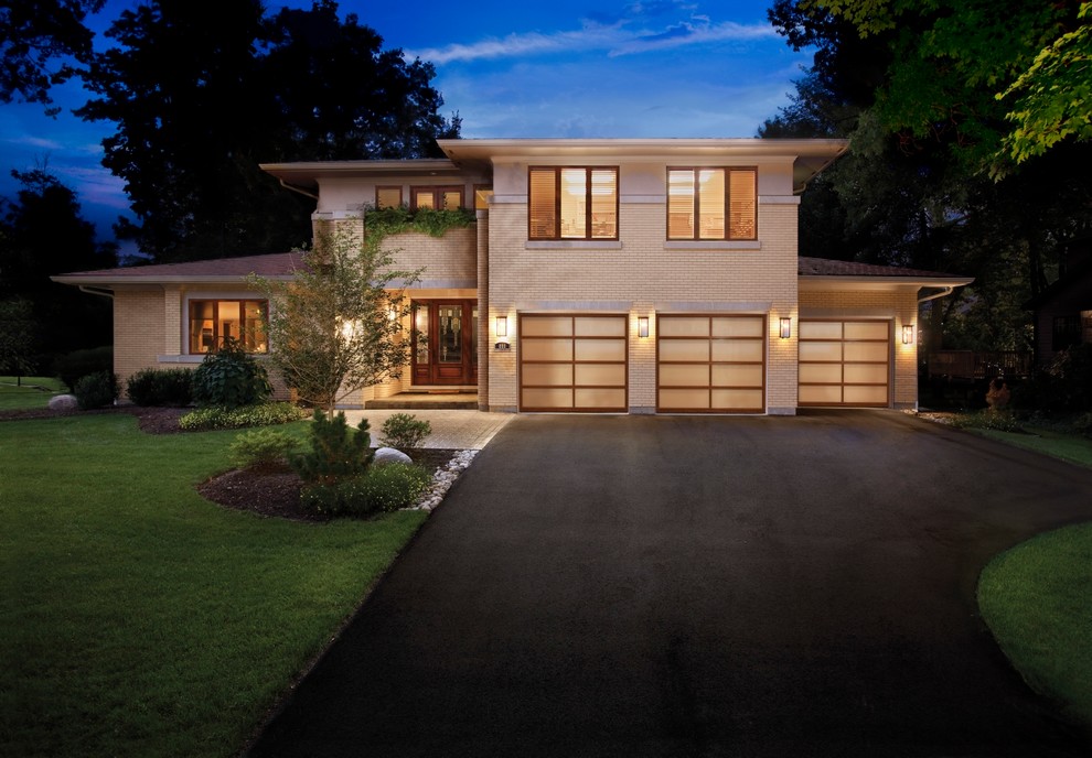 Inspiration for a large contemporary attached three-car garage in Raleigh.