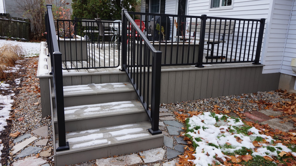 Deck skirting - mid-sized backyard ground level metal railing deck skirting idea in Detroit with no cover