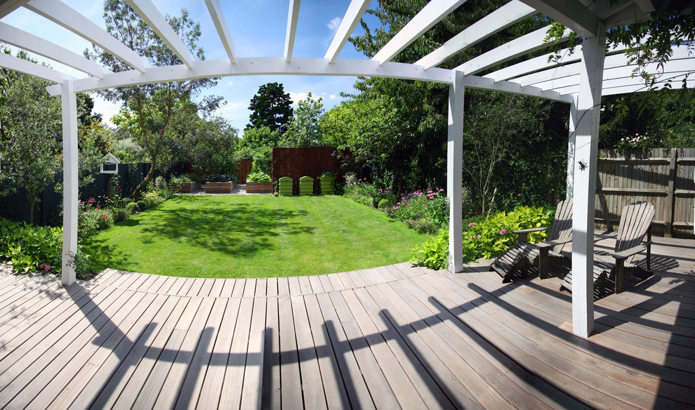 Photo of a large traditional backyard verandah in London with a vegetable garden, decking and a pergola.
