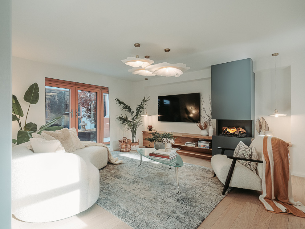 Large modern living room in Dublin With White Walls, a Metal Fireplace Surround, a Wall Mounted TV and a Drop Ceiling.