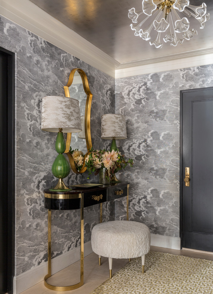 This is an example of a small transitional foyer in New York with limestone floors, a single front door and a black front door.