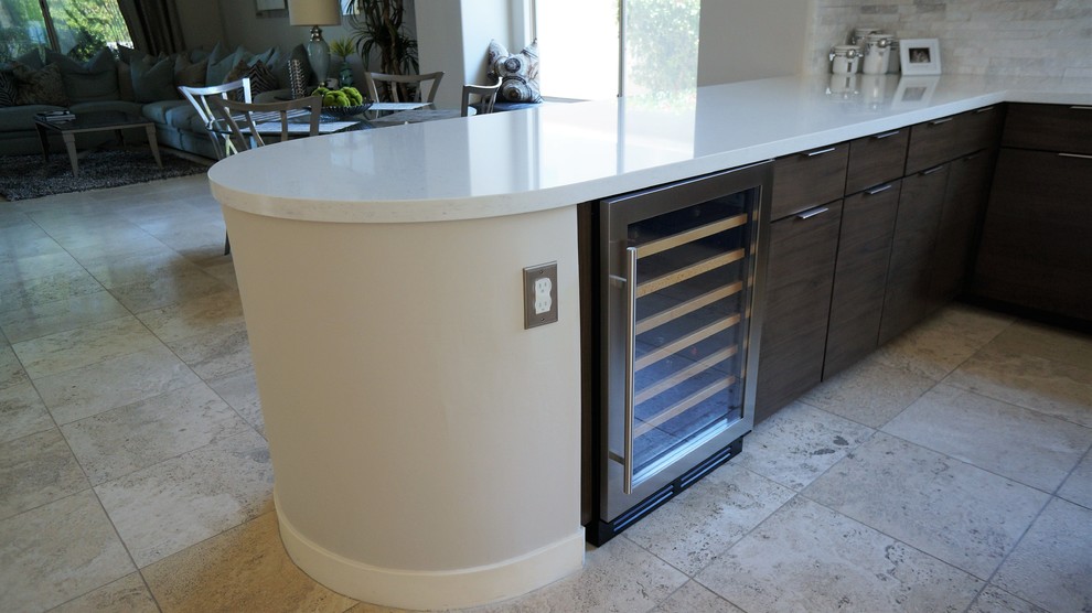 Open concept kitchen - mid-sized transitional u-shaped travertine floor and beige floor open concept kitchen idea in Phoenix with a single-bowl sink, flat-panel cabinets, light wood cabinets, quartz countertops, white backsplash, stone tile backsplash, stainless steel appliances and an island