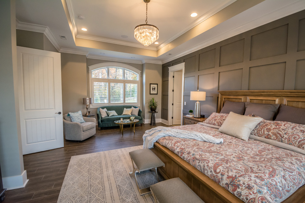 Photo of a large arts and crafts master bedroom in Nashville with beige walls, porcelain floors, no fireplace and brown floor.