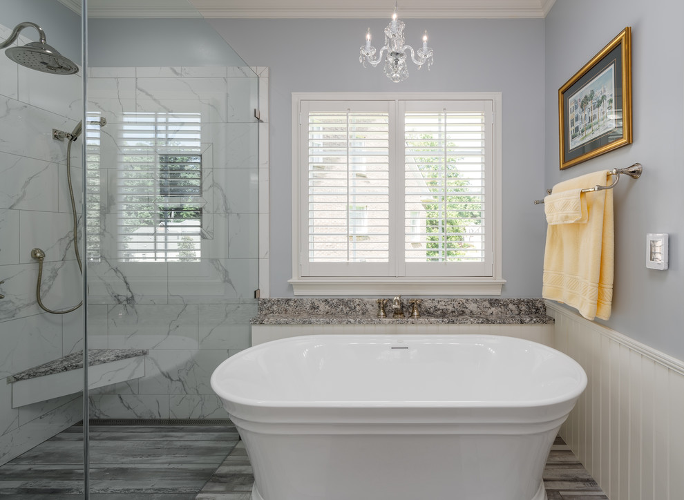 Mid-sized transitional master black and white tile and porcelain tile porcelain tile and gray floor freestanding bathtub photo with shaker cabinets, white cabinets, a two-piece toilet, gray walls, an undermount sink, granite countertops, a hinged shower door and gray countertops