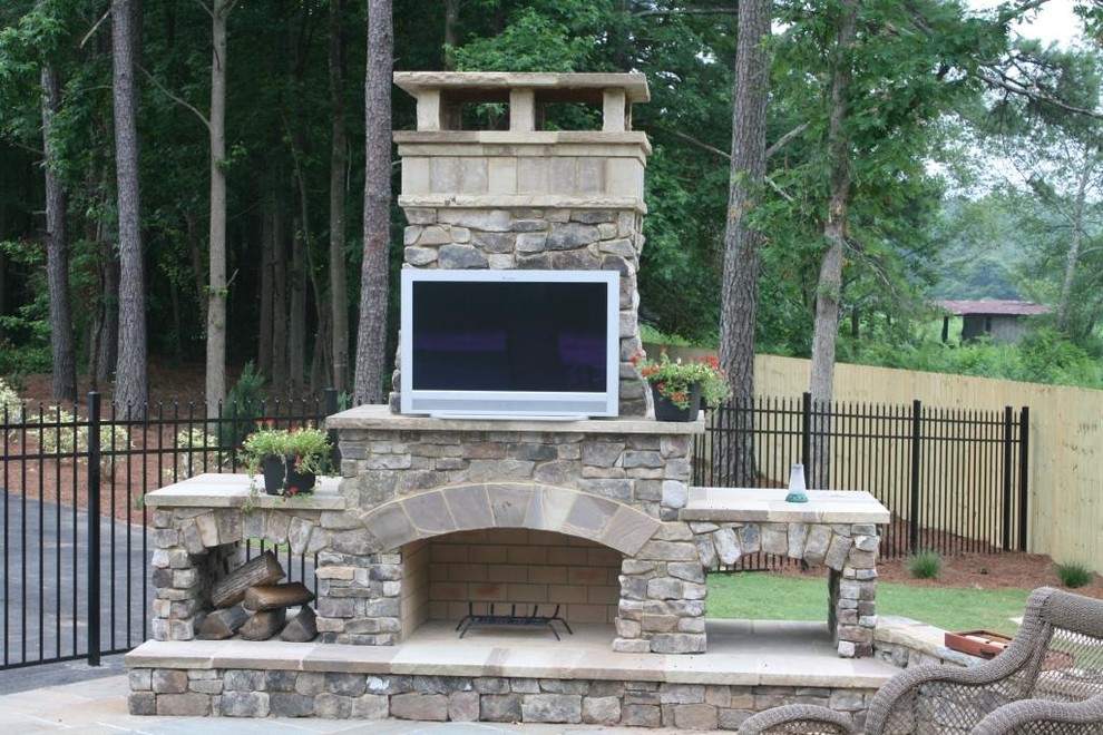 Mid-sized traditional side yard patio in Atlanta with with fireplace, natural stone pavers and no cover.