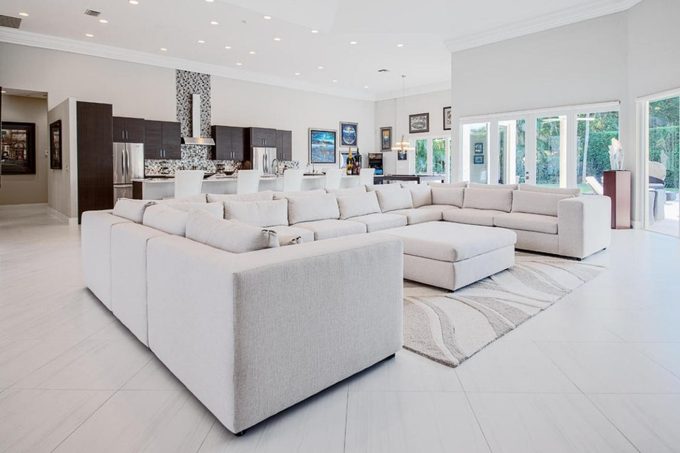 Inspiration for a large contemporary formal open concept living room in Miami with white walls and porcelain floors.