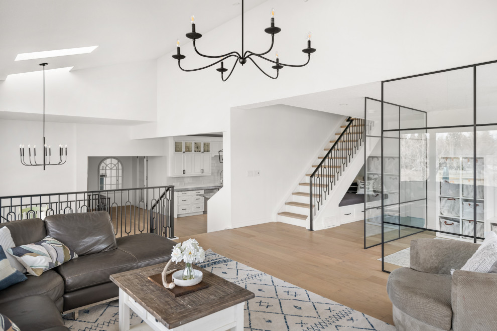 Inspiration for a contemporary gender-neutral kids' playroom for kids 4-10 years old in Calgary with white walls, light hardwood floors and brown floor.