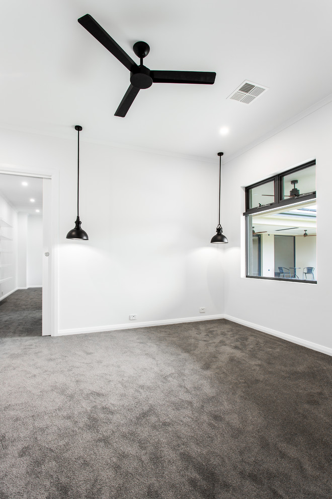 Large contemporary bedroom in Adelaide with white walls and carpet.
