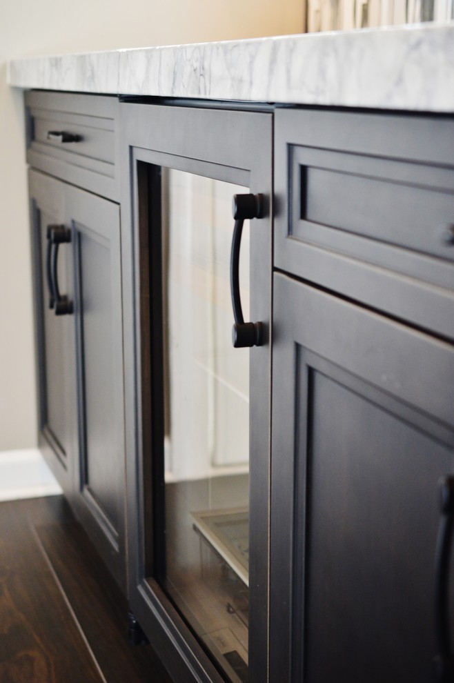 Example of a large transitional l-shaped dark wood floor enclosed kitchen design in DC Metro with an undermount sink, dark wood cabinets, white backsplash, subway tile backsplash, stainless steel appliances, two islands, shaker cabinets and marble countertops
