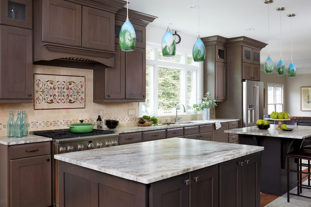 This is an example of a traditional kitchen in DC Metro with an undermount sink, shaker cabinets, dark wood cabinets, multi-coloured splashback, stainless steel appliances and multiple islands.