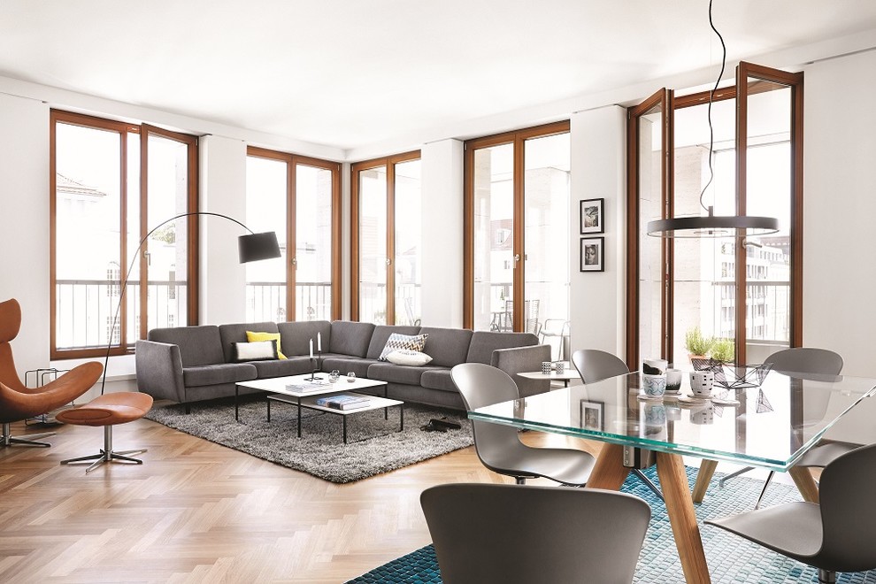 Photo of a large contemporary formal open concept living room in Dusseldorf with white walls and medium hardwood floors.