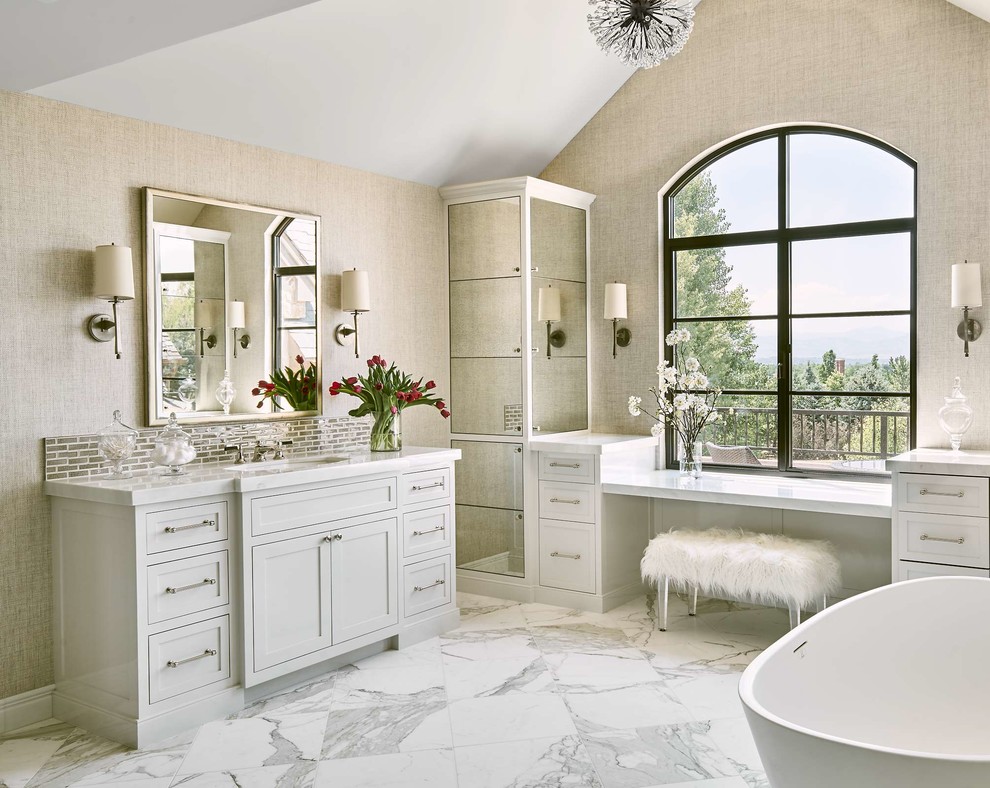 Inspiration for a large traditional master bathroom in Denver with a freestanding tub, white floor, white benchtops, shaker cabinets, grey cabinets, beige walls, marble floors and an undermount sink.