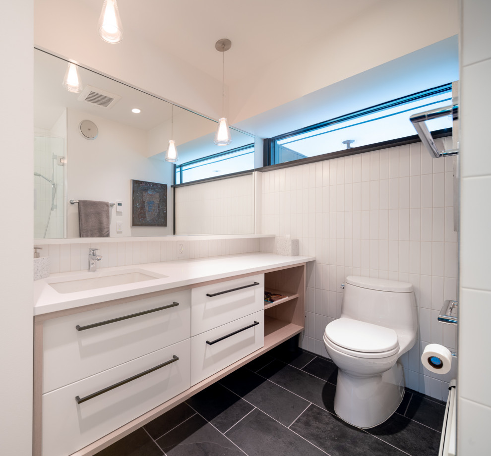 Design ideas for a small midcentury master bathroom in Minneapolis with an undermount sink, engineered quartz benchtops, a hinged shower door and white benchtops.