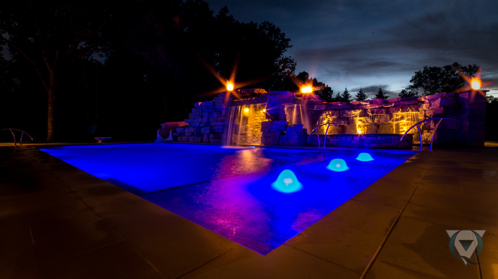Example of a large mountain style backyard stone and rectangular natural pool fountain design in Chicago