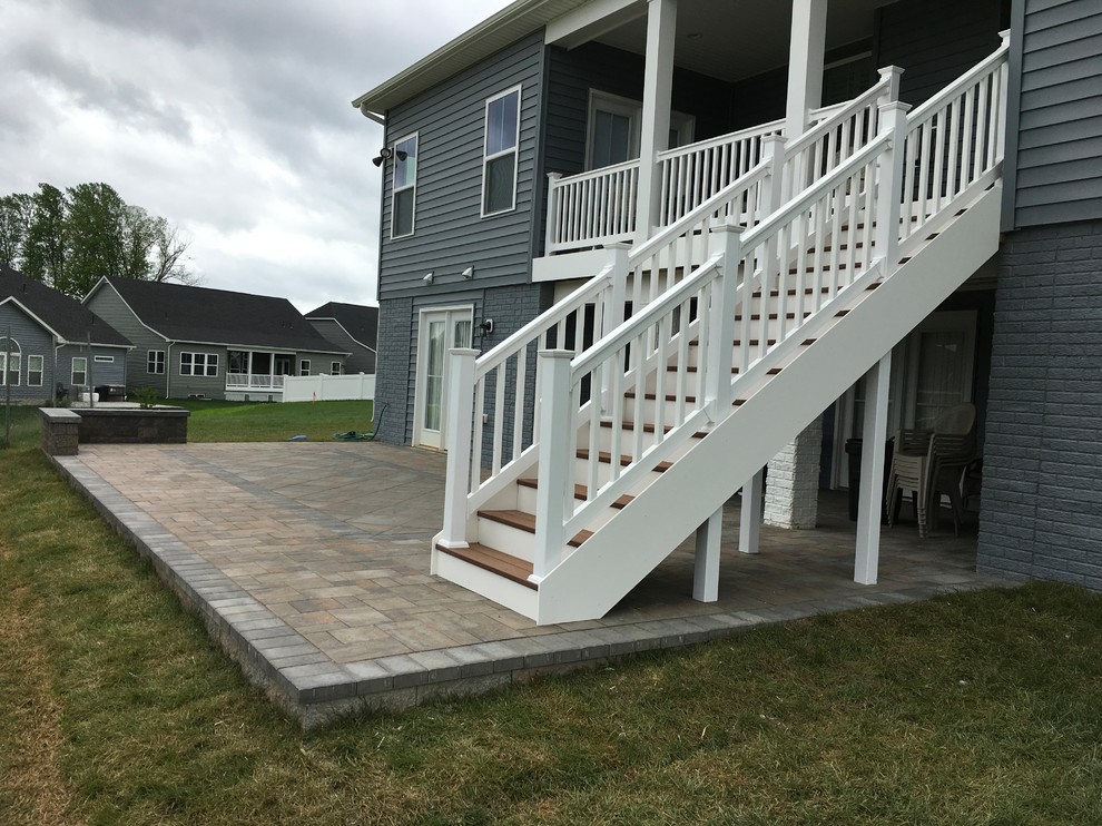 Example of a large backyard concrete paver deck design in Baltimore