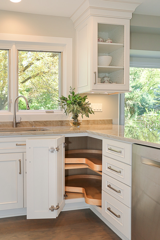 Inspiration for a small transitional galley light wood floor eat-in kitchen remodel in Chicago with an undermount sink, recessed-panel cabinets, white cabinets, quartzite countertops, gray backsplash, stone slab backsplash, stainless steel appliances and a peninsula