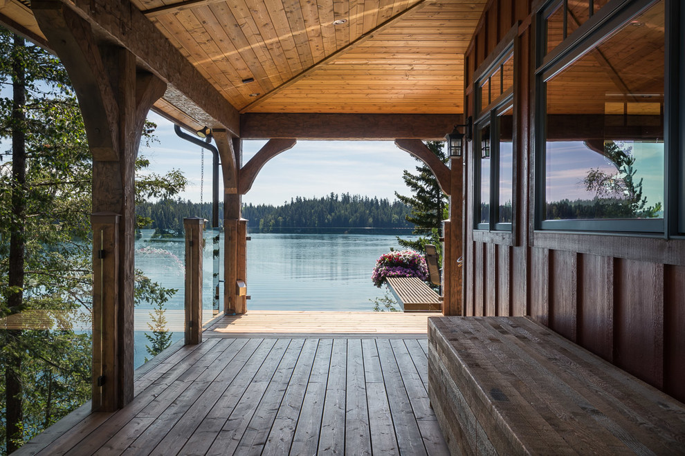 Inspiration for a mid-sized rustic side yard deck remodel in Jackson with a roof extension